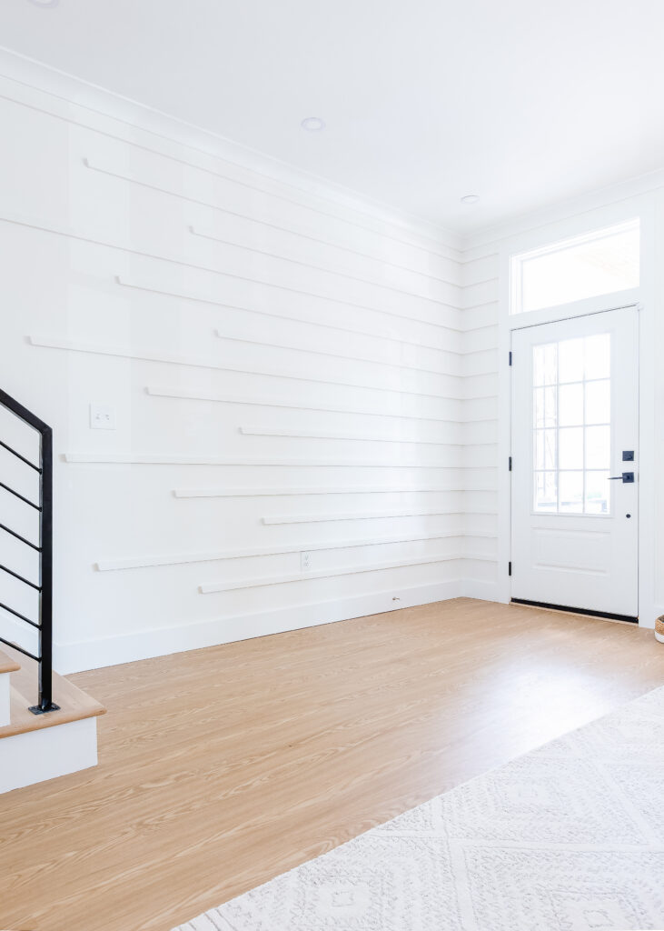 White and bright front entry way in an updated townhouse.